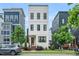 Striking three-story home boasts a contemporary design and professional landscaping at 606 Velma Hopkins Ln, Raleigh, NC 27603