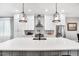 Contemporary kitchen features an island, pendant lights, and stainless steel appliances at 606 Velma Hopkins Ln, Raleigh, NC 27603