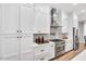 Bright kitchen features white cabinetry, stainless steel appliances, and modern finishes at 606 Velma Hopkins Ln, Raleigh, NC 27603