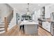 Spacious kitchen features white cabinets, a large island, and hardwood floors at 606 Velma Hopkins Ln, Raleigh, NC 27603