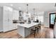 Open kitchen with a large island, stainless steel appliances, and modern pendant lighting at 606 Velma Hopkins Ln, Raleigh, NC 27603