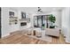 Modern living room featuring a fireplace, hardwood floors, and sliding glass doors to the backyard at 606 Velma Hopkins Ln, Raleigh, NC 27603