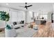 Open-concept living room flows into the kitchen, featuring modern lighting and a comfortable seating area at 606 Velma Hopkins Ln, Raleigh, NC 27603