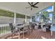 Screened back porch featuring a dining set, a seating area, and an outdoor fan at 609 Redford Place Dr, Rolesville, NC 27571