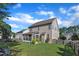 The backyard features a spacious lawn, a fenced perimeter, and a screened-in porch for outdoor relaxation at 609 Redford Place Dr, Rolesville, NC 27571
