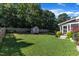 This backyard offers a spacious lawn, a storage shed, and access to a screened-in porch at 609 Redford Place Dr, Rolesville, NC 27571