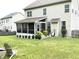 Backyard featuring a screened-in porch, green lawn, and landscaping at 609 Redford Place Dr, Rolesville, NC 27571