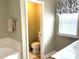 Charming bathroom showcasing a toilet, window, and vanity with sink for a clean and functional space at 609 Redford Place Dr, Rolesville, NC 27571