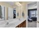 Bathroom featuring double sinks, cherry cabinets, and a view into the bedroom at 609 Redford Place Dr, Rolesville, NC 27571