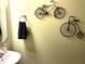 Stylish bathroom features a modern sink and unique bicycle-themed wall decor at 609 Redford Place Dr, Rolesville, NC 27571