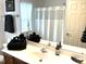 Bright bathroom features vanity with mirror, towels, sink, and shower at 609 Redford Place Dr, Rolesville, NC 27571