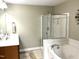 Well-lit bathroom features a walk-in shower and separate soaking tub, offering both convenience and relaxation at 609 Redford Place Dr, Rolesville, NC 27571