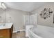 Bright bathroom featuring a soaking tub, stand up shower, and a single sink vanity at 609 Redford Place Dr, Rolesville, NC 27571