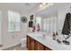 Bathroom with a single sink, cherry cabinets, and a window providing natural light at 609 Redford Place Dr, Rolesville, NC 27571