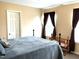 Cozy bedroom featuring a comfortable bed, charming crib and warm curtains adding a welcoming touch at 609 Redford Place Dr, Rolesville, NC 27571