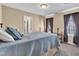 Bedroom featuring neutral walls and carpet with 2 windows and an adjoining bathroom at 609 Redford Place Dr, Rolesville, NC 27571