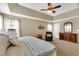 Inviting primary bedroom featuring a ceiling fan, tray ceiling, and ample natural light at 609 Redford Place Dr, Rolesville, NC 27571