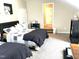 Comfortable bedroom with two beds, black shelving and doorway with carpeted floors at 609 Redford Place Dr, Rolesville, NC 27571