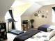 Bedroom features two beds, treadmill, TV, decorations and window at 609 Redford Place Dr, Rolesville, NC 27571