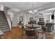 Dining area with hardwood floors, a chandelier, and easy access to the staircase and living area at 609 Redford Place Dr, Rolesville, NC 27571