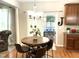 Cozy dining area with hardwood floors, a round table with chairs, and natural light from the sliding glass door at 609 Redford Place Dr, Rolesville, NC 27571