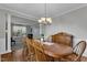 Elegant dining room features a wood table, hardwood floors, and a decorative light fixture at 609 Redford Place Dr, Rolesville, NC 27571