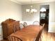 Traditional dining room features hardwood floors and a large wooden dining table at 609 Redford Place Dr, Rolesville, NC 27571