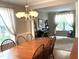Elegant dining room features a large wooden table and bright natural lighting at 609 Redford Place Dr, Rolesville, NC 27571
