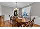 Elegant dining room featuring a large wooden table, chandelier, and natural light, perfect for Gathering gatherings and entertaining at 609 Redford Place Dr, Rolesville, NC 27571