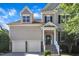 Beautiful home with a two-car garage and stone-accented front, offering a blend of modern convenience and classic design at 609 Redford Place Dr, Rolesville, NC 27571