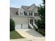 Traditional two-story home featuring a two-car garage, light siding, and manicured landscaping at 609 Redford Place Dr, Rolesville, NC 27571