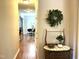 Hallway displaying hardwood floors leading to a dining room with a decorative wreath and wooden furniture at 609 Redford Place Dr, Rolesville, NC 27571
