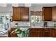 Bright kitchen with wood cabinets, stainless steel dishwasher, sink and gray countertop at 609 Redford Place Dr, Rolesville, NC 27571