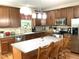 Beautiful kitchen with wooden cabinets, stainless steel appliances, a center island, and a window over the sink at 609 Redford Place Dr, Rolesville, NC 27571
