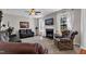A cozy living room offers a fireplace, ceiling fan, and comfortable seating with natural light at 609 Redford Place Dr, Rolesville, NC 27571