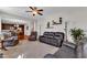 The living room features comfortable seating, a ceiling fan, with an open layout leading to the kitchen at 609 Redford Place Dr, Rolesville, NC 27571