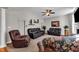 The spacious living room features comfortable seating, a ceiling fan, and a decorative fireplace at 609 Redford Place Dr, Rolesville, NC 27571
