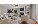 Bright living room featuring a fireplace, ceiling fan, neutral walls, and stylish furniture at 609 Redford Place Dr, Rolesville, NC 27571