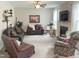 Spacious living room features a ceiling fan, fireplace, and comfortable seating at 609 Redford Place Dr, Rolesville, NC 27571