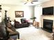Cozy living room with a fireplace, soft carpet and comfortable furnishings at 609 Redford Place Dr, Rolesville, NC 27571