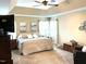 Main bedroom with natural light and tray ceiling, plush carpet, with a ceiling fan for added comfort at 609 Redford Place Dr, Rolesville, NC 27571