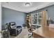 Office area featuring a large desk, comfortable seating, and natural light from a large window at 609 Redford Place Dr, Rolesville, NC 27571