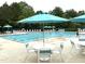Large community pool surrounded by plenty of lounge chairs and umbrellas, perfect for a relaxing day at 609 Redford Place Dr, Rolesville, NC 27571