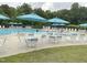 Community pool with lounge chairs and umbrellas at 609 Redford Place Dr, Rolesville, NC 27571