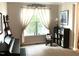 This sitting room has a piano, shelving and plenty of natural light at 609 Redford Place Dr, Rolesville, NC 27571