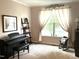 Music room with a black piano and sun-filled windows at 609 Redford Place Dr, Rolesville, NC 27571
