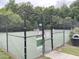 Community tennis court with black chain link fence and a small bench at 609 Redford Place Dr, Rolesville, NC 27571