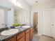 Bathroom featuring a double vanity, large mirror, and view into the water closet and shower at 611 Ashbrittle Dr, Rolesville, NC 27571