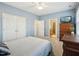 Light blue bedroom featuring a ceiling fan, carpet, and access to an ensuite bathroom and closet at 611 Ashbrittle Dr, Rolesville, NC 27571