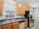 Well-maintained kitchen with wood cabinets, stainless steel appliances, and a double sink at 611 Ashbrittle Dr, Rolesville, NC 27571